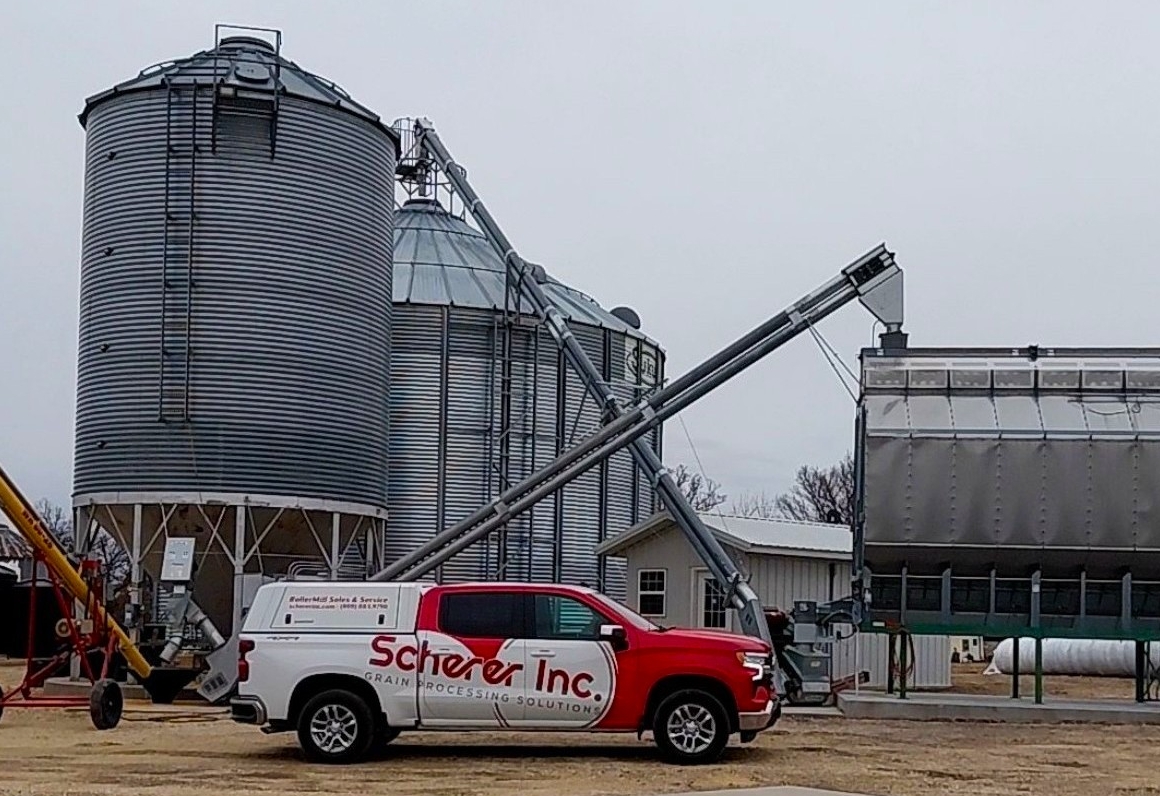 Scherer service truck parked at an agricultural site for maintenance work.